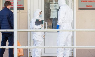 Doctors in Personal Protective Equipment Stand with Suspected Coronavirus Man | Is Russia Leading the COVID-19 Vaccine Race? | Featured