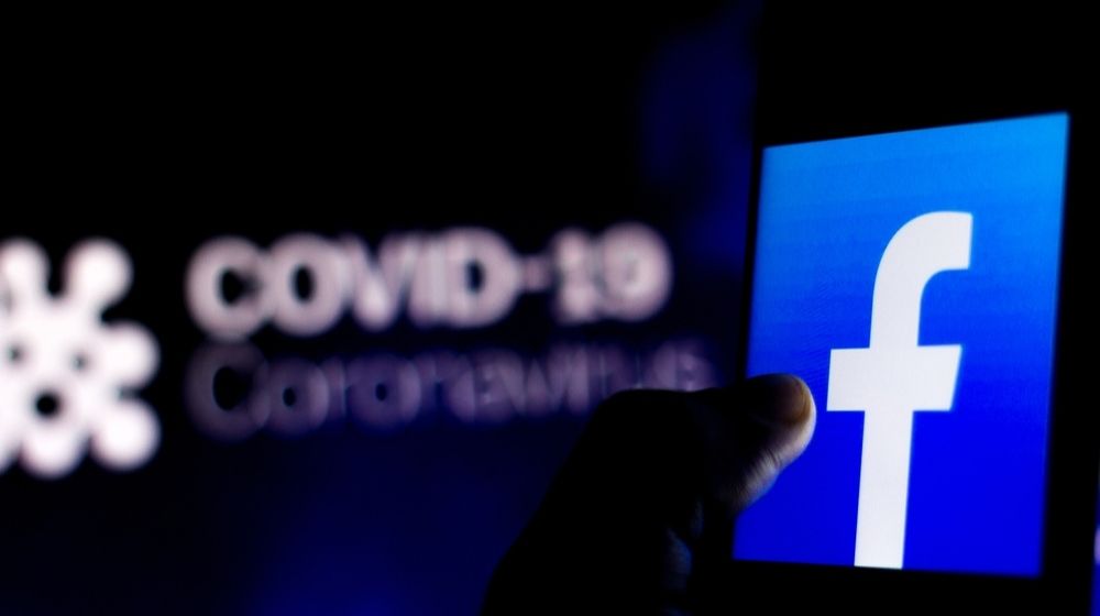 Facebook logo seen displayed on a smartphone | Facebook and Instagram Remind Users to Wear Masks | Featured