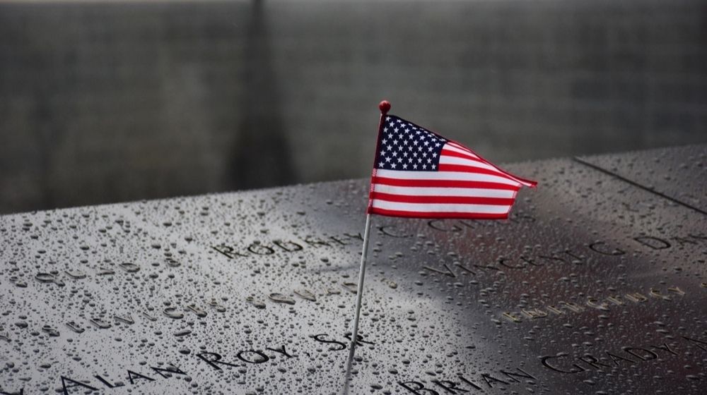 Memorial at Ground Zero Manhattan for September 11 Terrorist Attack with an American Flag | Vandalism at 9/11 Memorial Prompts Outpouring of Donations and Support | Featured