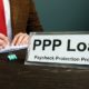 PPP Loan Title on the Plate in the Office | Big Businesses Cash in on Forgivable PPP Loans | Featured