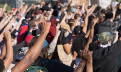 Protestors Raise their Hands in Solidarity Outside of the Fifth Police Precinct in Minneapolis | Minnesota Gov. Tim Walz Asks Trump for Federal Disaster Declaration Following Damages | Featured