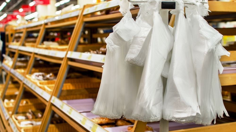 Stand with Cellophane Plastic Bags in the Bread Department Store | Major Retailers Collaborate to Find Alternative to Single-Use Plastic Bags | Featured