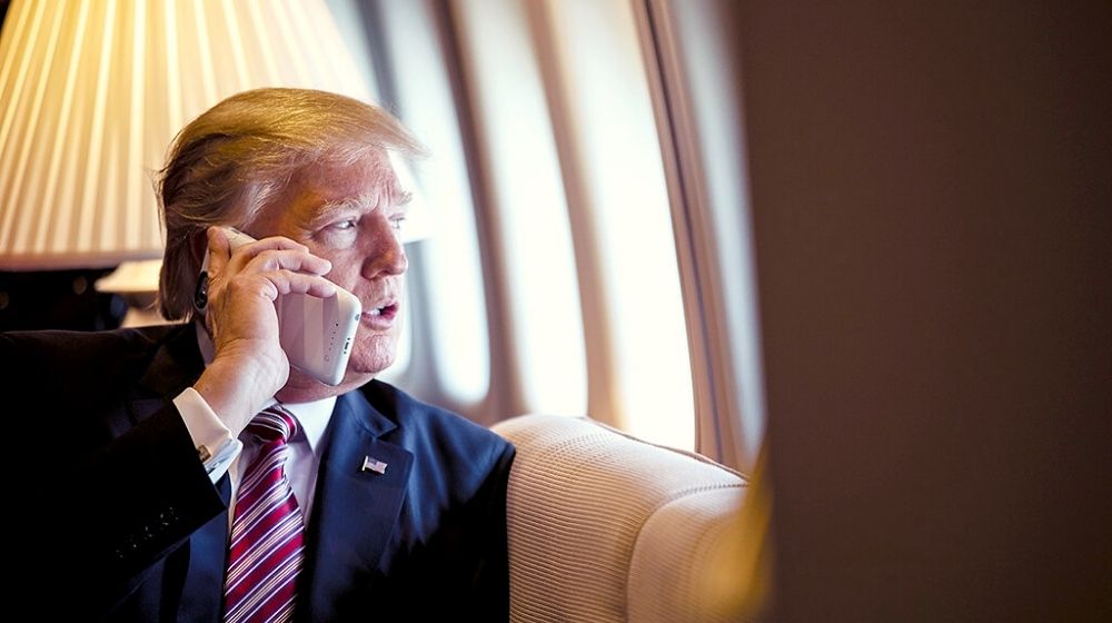 President Donald Trump talking on the phone | Twitter Disables Trump Tweet over Copyright Complaint | Featured
