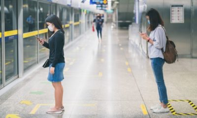 Two Young Asian Woman Wearing Protective Face Mask | Experts Call for Federal Intervention as Top Doc Warns COVID-19 Cases Could Top 100K Per Day | Featured