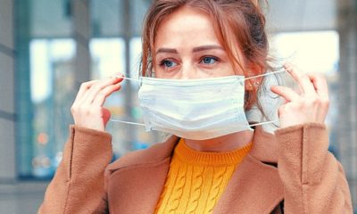 woman wearing a surgical mask | Johns Hopkins Senior Scholar and Coronavirus Expert Says Face Coverings Are a Vital Defense | Featured