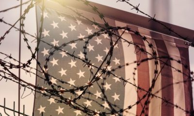 American Flag and Barbed Wire | Former Trump Aide Steve Bannon Arrested in Donor Fraud Case | Featured