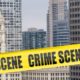 Crime Scene Cordon Tape Superimposed over Chicago Skyline | 8 Dead and At Least 19 Wounded in Weekend Chicago Shootings | Featured