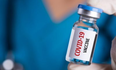 Doctor with a Stethoscope on Shoulder Holding a COVID-19 Vaccine | Russia Announces COVID-19 Vaccine, But Western Docs Doubt Safety Standards | Featured