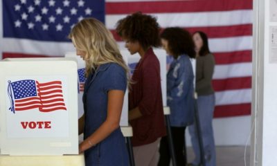 Four Women of Various Demographics Filling in Ballots and Casting Votes in Booths | Should We Delay the Election? | Featured