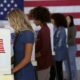 Four Women of Various Demographics Filling in Ballots and Casting Votes in Booths | Should We Delay the Election? | Featured