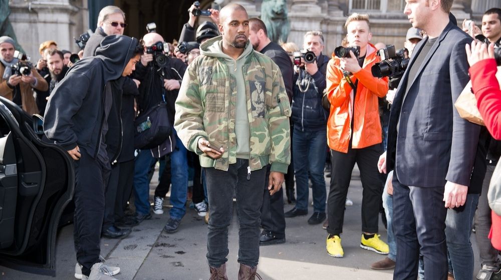 Kanye West Posing for Photographers | Kanye West Envisions “Jesus Tok” as He Was “Disturbed” by Tiktok Content | Featured