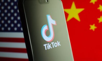 TikTok App Logo on a Smartphone Screen and Flags of China and United States on the Background | President Trump Bans TikTok and WeChat from the US, Unless Companies are Sold within 45 days | Featured