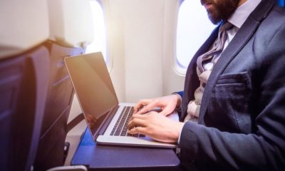 Unrecognizable Young Businessman with Notebook Sitting Inside an Airplane | Laptop Battery Catches Fire on an Alaska Airlines Boeing 737 | Featured