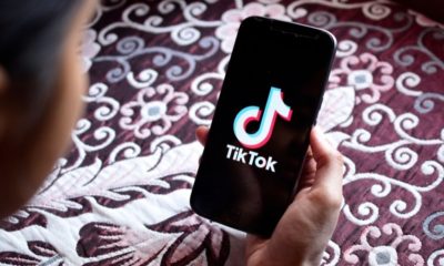 Woman holding Motorola phone with TikTok Application on the Screen | TikTok CEO Resigns Amid US Pressure to Sell Video App | Featured