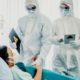 Doctors in Protective Suits and Masks Examining the Infected Aging Patient | U.S. Reports More Than 50,000 New COVID-19 Cases as Labor Day Weekend Kicks Off | Featured