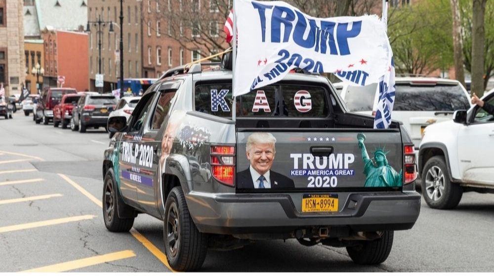 people in cars with American Flags and Trump flags | | Featured