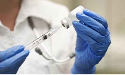 Medication Nurse Wearing Protective Gloves Get a Needle Ready for an Injection | American Medical Association Says the Flu Vaccine This Year “Is More Important Than Ever” | Featured
