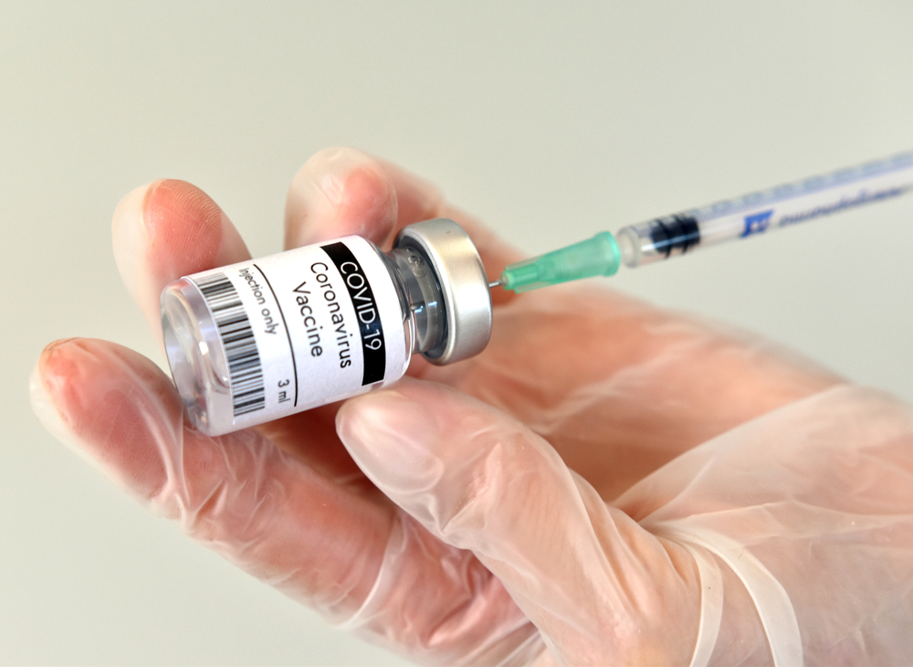 A person holding a syringe and a Covid-19 vaccine vial-Trump Praises Vaccine from Moderna- “These Great Discoveries, Which Will End the China Plague, All Took Place on My Watch!”-ss-featured.jpg