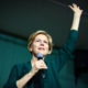 Elizabeth Warren speaking at a campain with one hand raised-Sanders and Warren at Risk of Being Excluded from the Biden Administration's Senior Ranks-ss-Featured