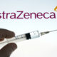 Person holding a syringe with the AstraZeneca logo in the background-AstraZeneca’s Phase 3 Data Is Expected to Be Available by Christmas-ss-featured