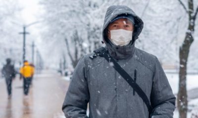 Portrait of a Man Wearing a Medical Protective Mask on his Face in Winter | Brace Yourselves: COVID-19 Winter Is Coming | Featured