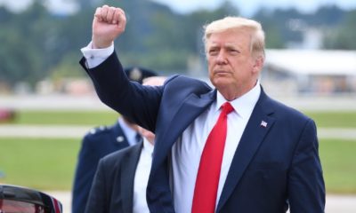 President Donald Trump gives a fist pump arriving at Dobbins Air Reserve Base-trump leaving white house-ss-featured