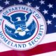 The symbol of the US Department of Homeland Security pictured over the USA Flag | Alejandro mayorkas