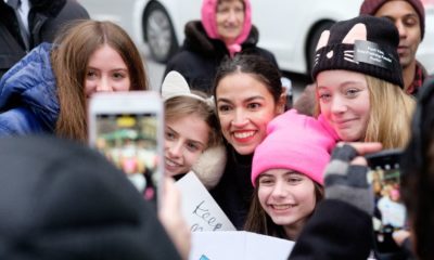 Alexandria Ocasio-Cortez (center) takes photos with fans waiting for a cab after the Women's Unity Rally in New York-Sex Work is Work-ss-featured