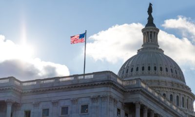 American flag waving atop of United States Capitol Building as the sun shines brightTrump’s Defense Bill Veto-ss-featured