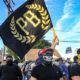 Members of the Proud Boys organization holding their flag in Washington D.C. - Trump Rally in D.C. Turns Violent-ss-Featured