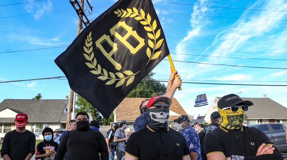Members of the Proud Boys organization holding their flag in Washington D.C. - Trump Rally in D.C. Turns Violent-ss-Featured