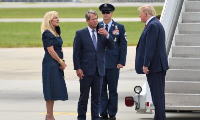 President Donald Trump greets Georgia Governor Brian Kemp and Georgia First Lady Marty Kemp upon exiting Air Force One at Dobbins Air Reserve Base-Kemp to Resign-ss-featured