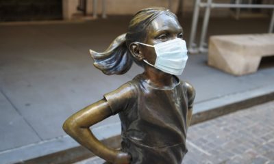 The Fearless Girl Statue in New York City wears a mask as the COVID-19 coronavirus spreads across the world-Wall Street Continue to Rise in 2021-ss-featured