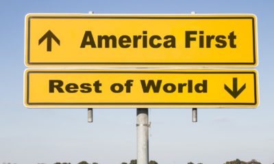 yellow traffic and direction sign with two arrows showing up and down and the words America first and Rest of world-America First for COVID-19 vaccines-ss-featured