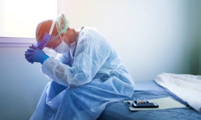 A medical worker in a PPE suit-US Vaccine Shortages Cause Cancelations-ss-featured