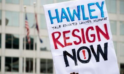 A protest sign reading Hawley Resign Now at a rally calling for the resignation of Senator Josh Hawley-Ted Cruz and Josh Hawley To Resign-ss-featured