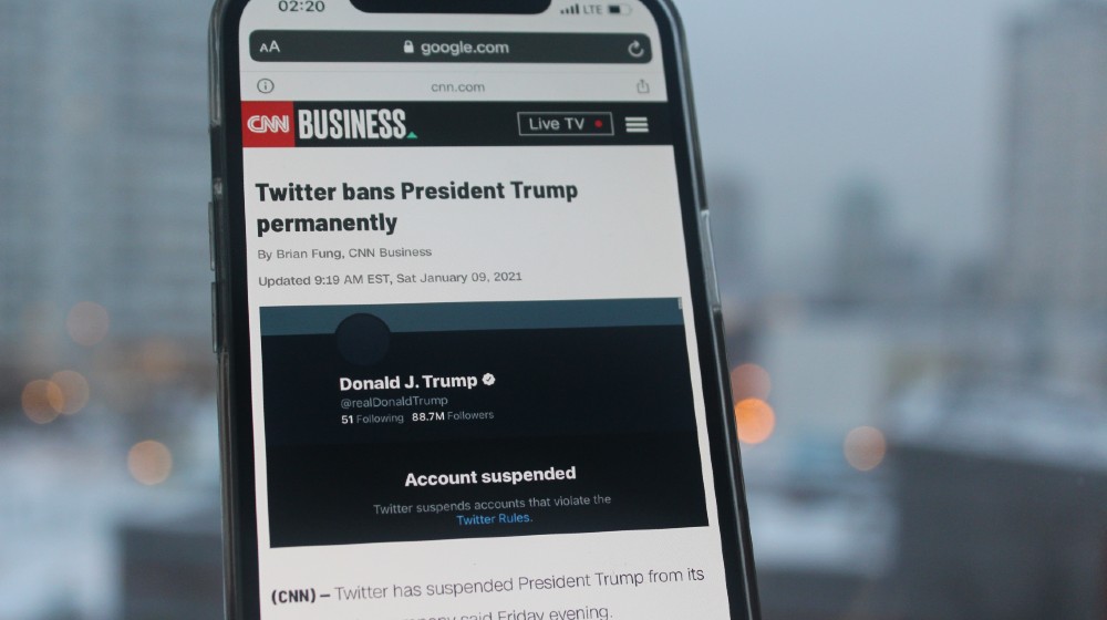 CNN news with Twitter bans President Trump permanently headlines on smartphone screen-Trump’s Twitter Ban-ss-featured