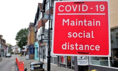 Street sign reminding people to maintain social distance-National Lockdown For England Expected to Last Until Mid-February-ss-Featured