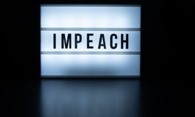 Text in english on lightbox sign spelling Impeach-Greene will file impeachment-ss-featured