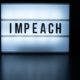 Text in english on lightbox sign spelling Impeach-Greene will file impeachment-ss-featured