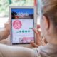 Woman downloading the Airbnb app-Airbnb and HotelTonight Cancel All Washington D.C. Reservations Before Inauguration-ss-Featured