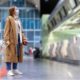 Woman with luggage stands at almost empty check-in counters at the airport terminal due to coronavirus pandemicCovid-19 outbreak travel restrictions-Requiring COVID Tests-ss-featured