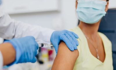 Female doctor or nurse giving shot or vaccine to a patient's shoulder-Enough COVID-19 Vaccines-ss-featured