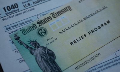 Form 1040 U.S. Individual Income tax return next to the Stimulus Check Relief program-Pass Stimulus Plan-ss-featured