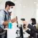Male traveler shows phone to female officer at airline check in counter for issue airplane ticket boarding pass-Airline Travel Pass-ss-featured