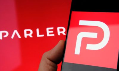 Parler app logo seen on the screen of smartphone and on the blurred background-Parler Returns-ss-featured