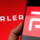 Parler app logo seen on the screen of smartphone and on the blurred background-Parler Returns-ss-featured