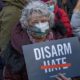 A woman holds a sign that reads _disarm hate_ at a peace vigil to honor victims of attacks on Asians in Union Square Park-Asian Hate-SS-Featured
