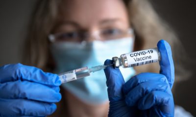 COVID-19 vaccine in researcher hands, female doctor holds syringe and bottle with vaccine for coronavirus cure-Americans Will Refuse-SS-Featured
