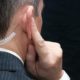 Close-up of a secret service agent listening to his earpiece, over the shoulder-Hunter Biden-ss-featured